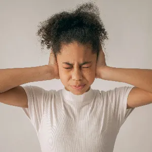 A woman suffering from ear pain