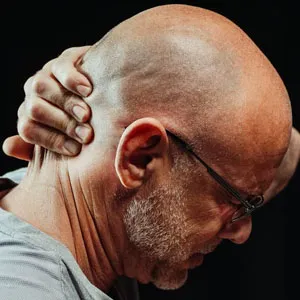 Man experiencing pain behind his ear due to tmj